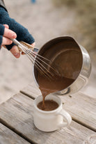 Harth hot chocolate being poured from a saucepan into a mug