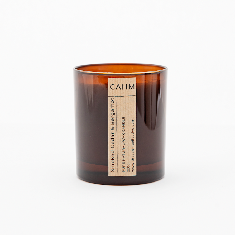 A Smoked Cedar and Bergamot Candle from the Amber Glass Candle collection by The CAHM Collective.