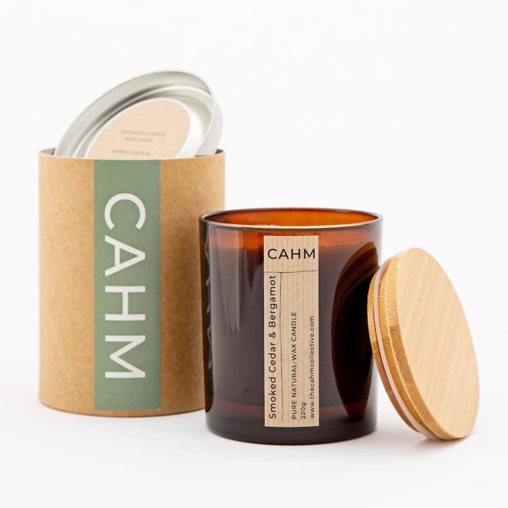 A Smoked Cedar and Bergamot Candle from the Amber Glass Candle collection by The CAHM Collective.