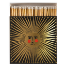 Matches in a decorative box with a sun design on a white background
