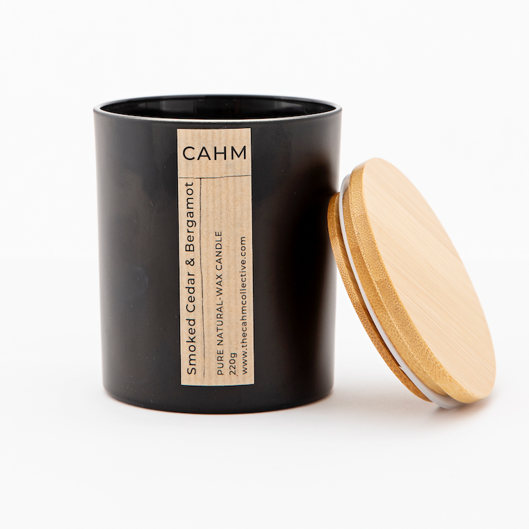 A Smoked Cedar and Bergamot Candle from the Black Glass Candle collection by The CAHM Collective.