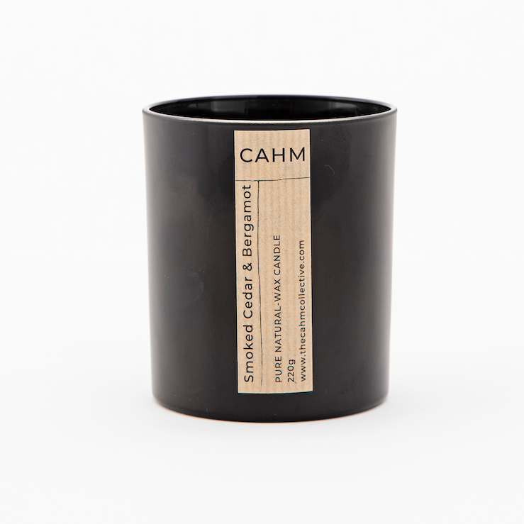 A Smoked Cedar and Bergamot Candle from the Black Glass Candle collection by The CAHM Collective.