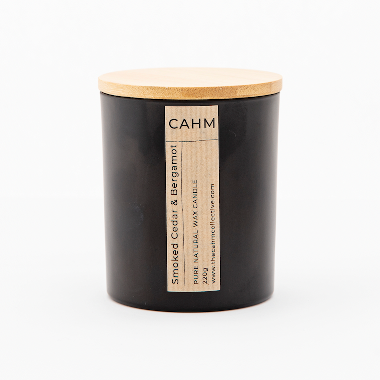 A Smoked Cedar and Bergamot Candle from the Black Glass Candle collection by The CAHM Collective.