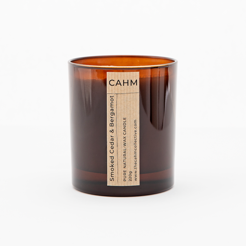 A Smoked Cedar and Bergamot Candle from the Amber Glass Candle collection by The CAHM Collective.