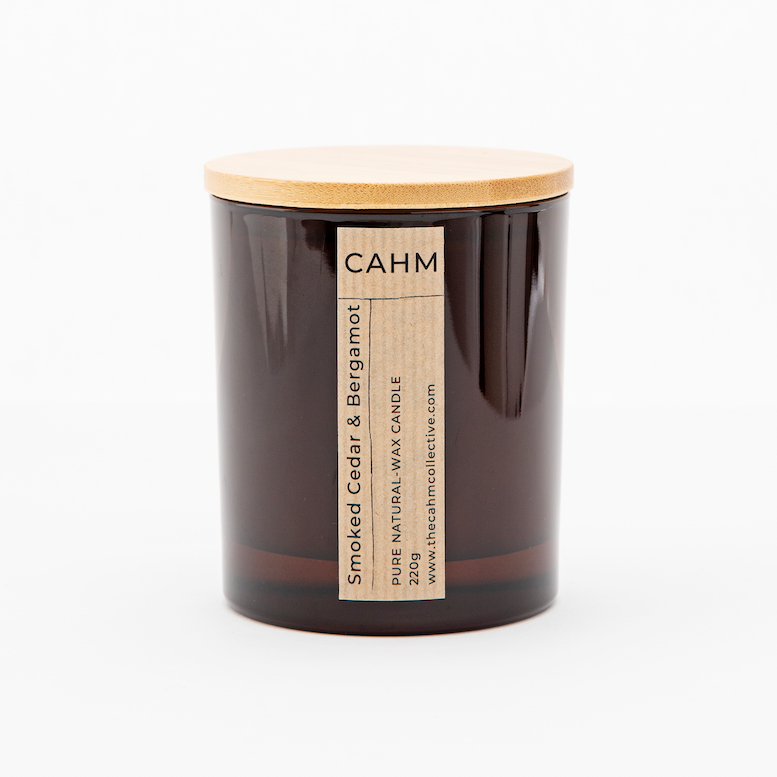 A Smoked Cedar and Bergamot Candle from the Amber Glass Candle collection by The CAHM Collective.